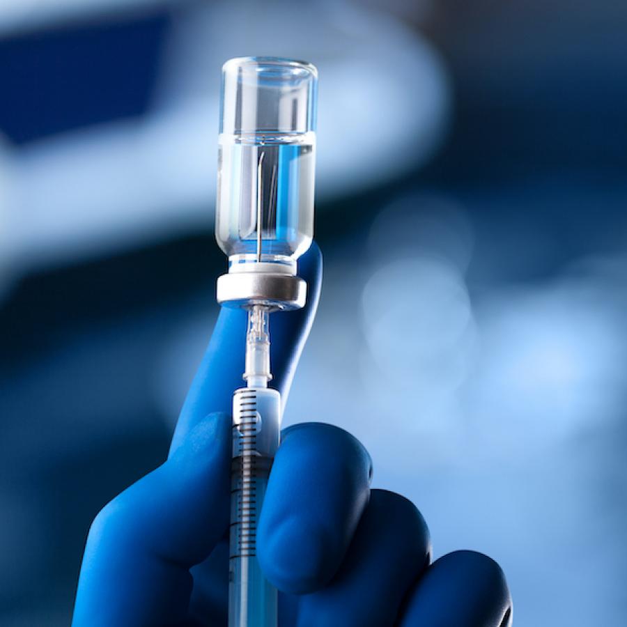 medical professional with vaccine vial