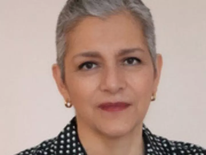 female with grey hair, black and white shirt