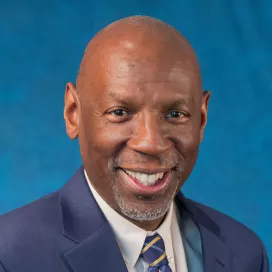 male wearing blue suit, white shirt